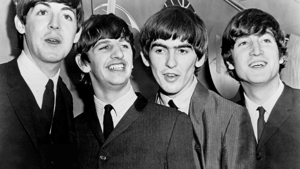 BEATLES, THE: Paul McCartney, Ringo Starr, George Harrison, John Lennon, being interviewed at the airport, during their first US tour in February, 1964.